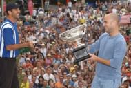 Darren Cahill sprays champagne over Andre Agassi following the latter's 2003 Australian Open triumph.